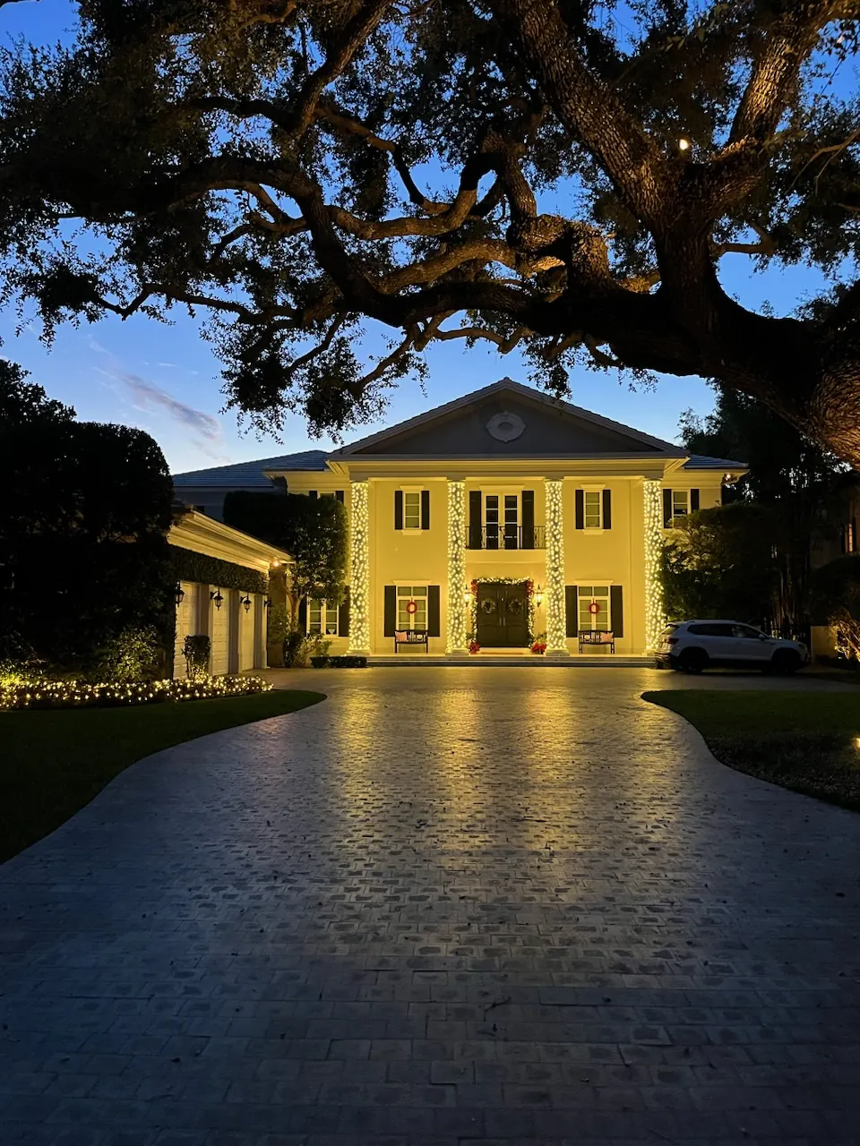 A Coral Gables estate hand-lit by Happy Lights of Miami at twilight