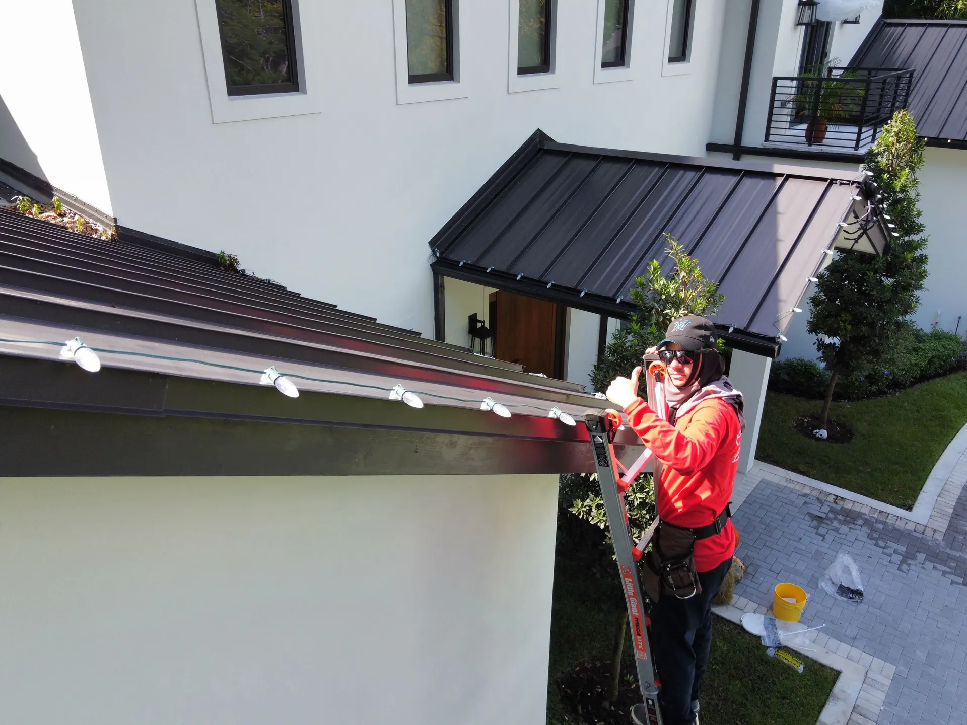 A Happy Lights crew member installing pro-grade lights on a Miami rooftop